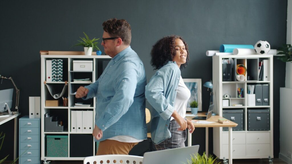 Man and woman back to back in office